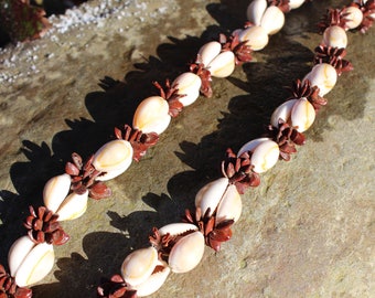 A vintage shell and seed long necklace