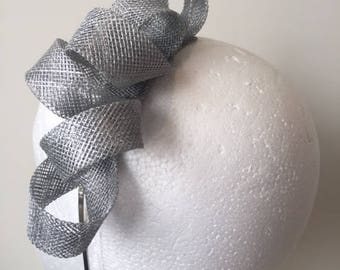 Silver sinamay loop fascinator on a metal headband. Gorgeous on!