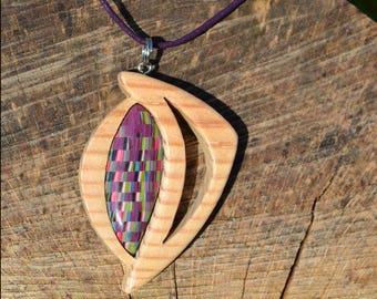 Pendant made of wood and accented with colored polymer clay