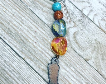 Beaded key chain featuring rusty cowboy boot.