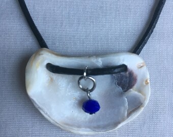 Unique oyster shell with blue charm