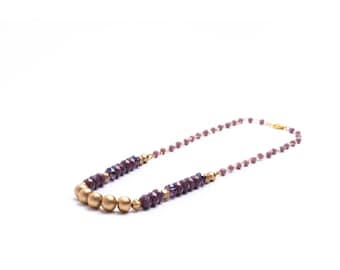 Purple and gold beaded necklace on rosary chain