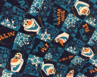Olaf print in all cotton.the backing is a turquoise minky,and Machine quilted by me. An heirloom quality quilt.