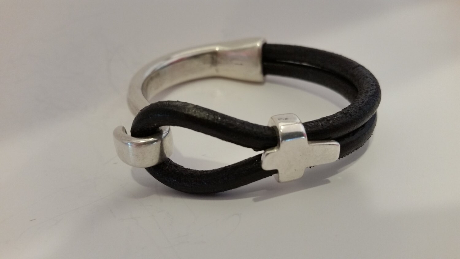 Black round leather bracelet with a silver half cuff and