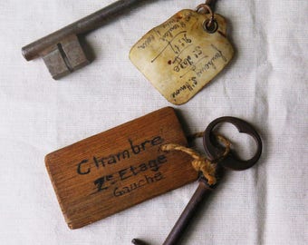 Two antique hotel keys with name tags