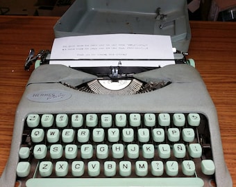 1957 Seafoam Green Hermes Baby ultra portable typewriter with Spanish keyboard