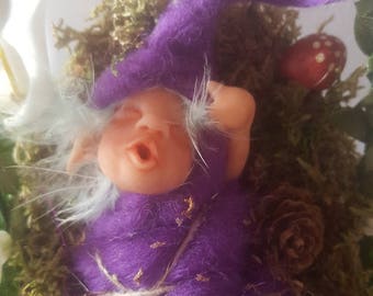 Ooak Elf yawning in his crib of forest, pineapple-bird mushrooms made in Sculpey and felt