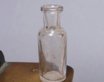 Antique miniature clear glass bottle, medical or laboratory bottle.