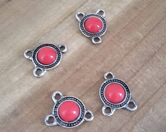 A set of 4 red ethnic connectors silver