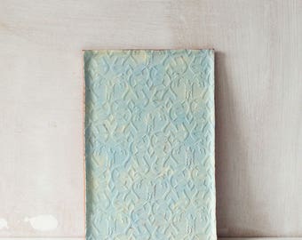 Handmade turquoise and yellow ceramic vanity tray with decorative imprint