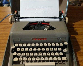 1957 Royal Quiet Deluxe portable typewriter with case, brush, and key to lock the case