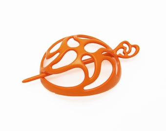 80's vintage hair bun holder, bright orange plastic bun cage, paisley pinwheel cutout oval
