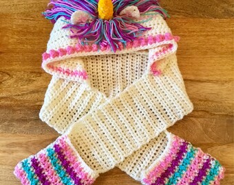 Unicorn hat with attached scarf and pockets .
