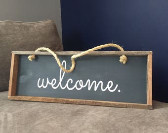 Welcome sign. Framed in reclaimed wood with a rope hanger.