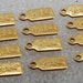Mattel 1998 Barbie Metal Tag Brass Charm STamped Lot of 12