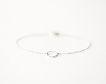 Geometric silver bracelet with karma circle pendant