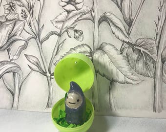 Blue sprite in a green easter egg, fairy garden sprite