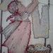 Completed Hummel cross stitch of a girl hanging laundry