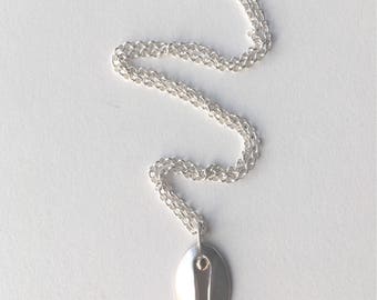 Silver and gold contemporary vulva pendant.