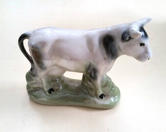 Staffordshire style cow figurine