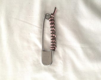 Large safety pin , woven leather