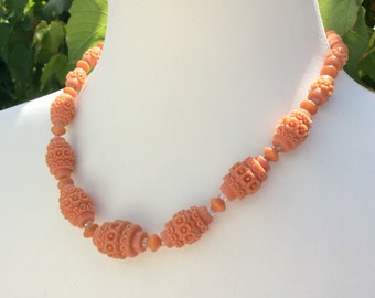 Coral coloured carved molded bead plastic necklace