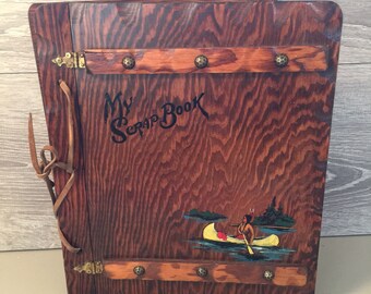 Vintage Wooden Srapbook with an Indian Paddling a Canoe