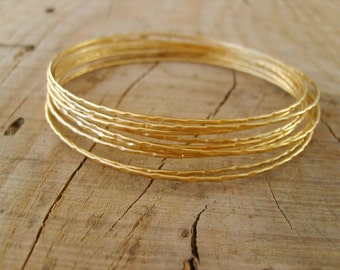 Hand crafted thin bangle bracelets in gold, gold bangle bracelets