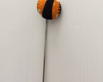 Orange and black lapel pin