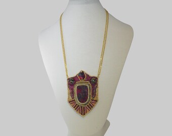 The pendant is embroidered around a Eudyalite
