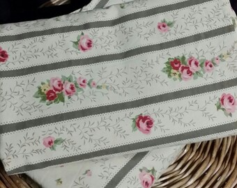 An adorable 2 pc. stripe, leafy rose, bed set, 100% cotton. One twin flat sheet and on twin size fitted sheet .