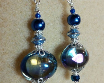 Not for the faint of heart. Statement earrings, lamp work focal in shimmering dark teal with crystal and silver