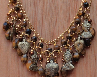 Mexican Milagro necklace with gold colored Milagros with tigers eye beads