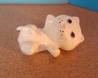 Beige cat with blue eyes and pink nose relaxing cat figurine
