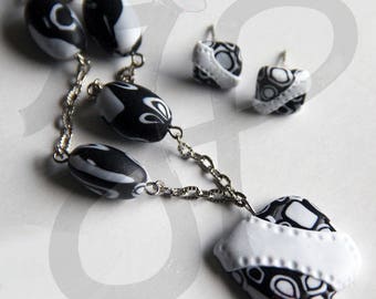 Parure with earrings and necklace with black and white surveyors