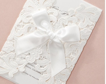 Pearl white floral wrap wedding invitations with ribbo