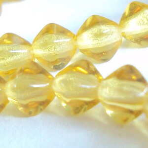 Czech glass x 100, Topaz, 6mm bicone, pressed beads