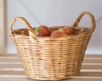 Tall oval vintage handwoven wicker storage basket with handles