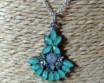 Silver necklace with a blue charm