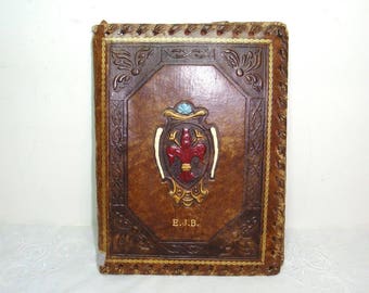Leather stationary folder, writing center with nylon lined pouches. and a pen or pencil slip. .6" wide, 73/4" tall. Embossed Fleur de Lis