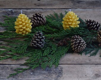 TWO English beeswax candles in the shape of a pine cone.