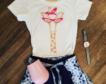 caramel giraffe with pink glases and bandana t-shirt