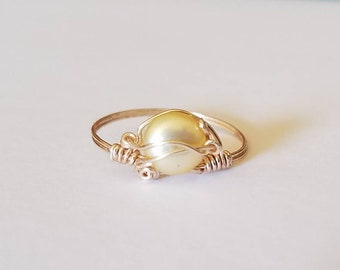 Rose gold wire with yellow freshwater pearl.