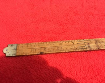 Stanley Number 61 folding Boxwood Ruler. Circa 1930 with brass ends and hinges. 24 inches long. Graduated in 1/8" and 1/16" increments.