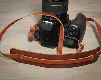 Hand made in the UK, leather copper riveted camera strap with moveable shoulder pad.