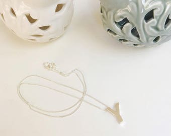 Initial embossed in sterling silver