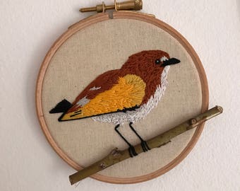 Yellow embroidered Bird on branch