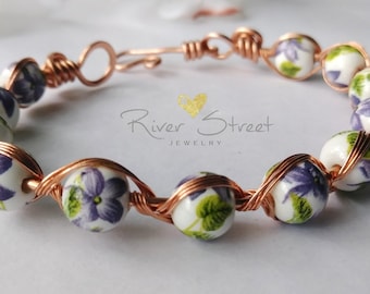 Purple flowers and copper bracelet
