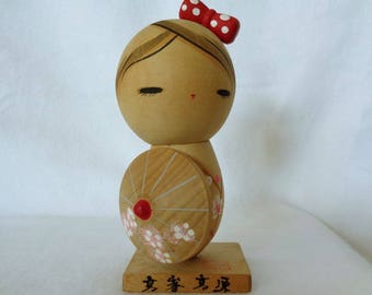 1064: Kokeshi doll, Vintage Japanese wooden Kokeshi doll on stand, signed,Handcrafted in Japan