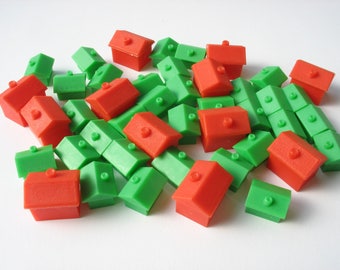 40 vintage Monopoly game pieces, 28 plastic houses and 12 hotels